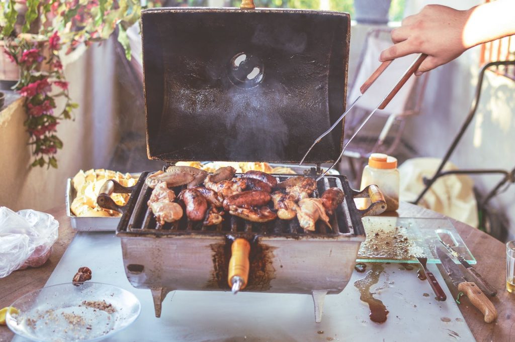 Home Grilled meats and vegetables cooking on an outdoor barbecue grill. Perfect for summer gatherings.